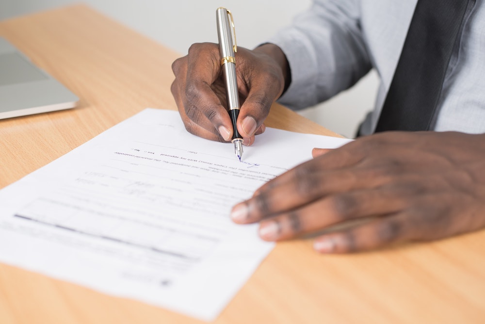 man signing a short term rental agreement